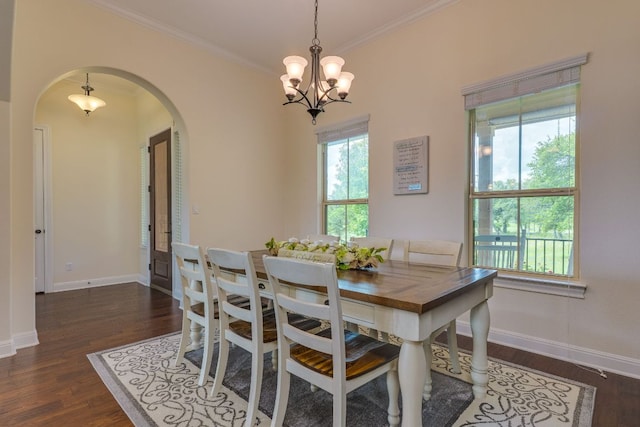 201 Thomas Ridge Rd, Burnet, TX 78611 - dining room featuring arched walkways, ornamental molding, plenty of natural light, a chandelier, and dark wood-type flooring