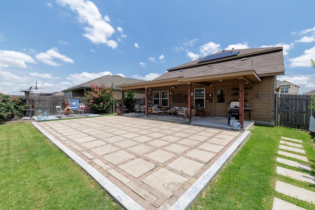 17020 Lathrop Ave, Pflugerville, TX 78660 - rear view of property with roof mounted solar panels, a patio area, a ceiling fan, and a fenced backyard