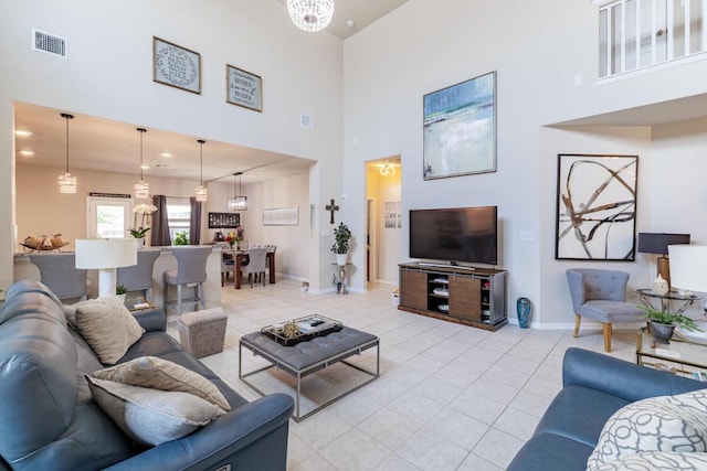 17020 Lathrop Ave, Pflugerville, TX 78660 - living area featuring a towering ceiling, light tile patterned floors, and a chandelier