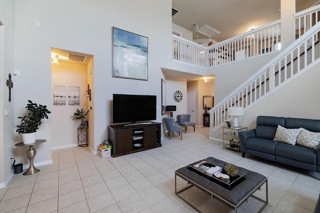 17020 Lathrop Ave, Pflugerville, TX 78660 - living room with a high ceiling, stairs, and tile patterned floors