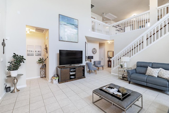 17020 Lathrop Ave, Pflugerville, TX 78660 - tiled living room featuring stairway and a high ceiling
