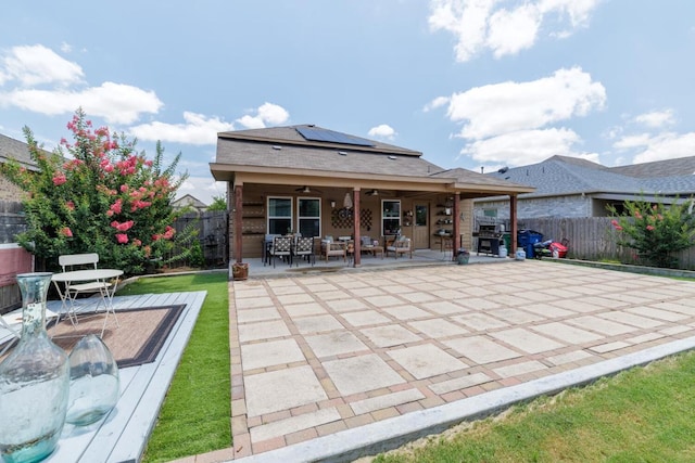 17020 Lathrop Ave, Pflugerville, TX 78660 - back of property with ceiling fan, solar panels, a fenced backyard, and outdoor dining area
