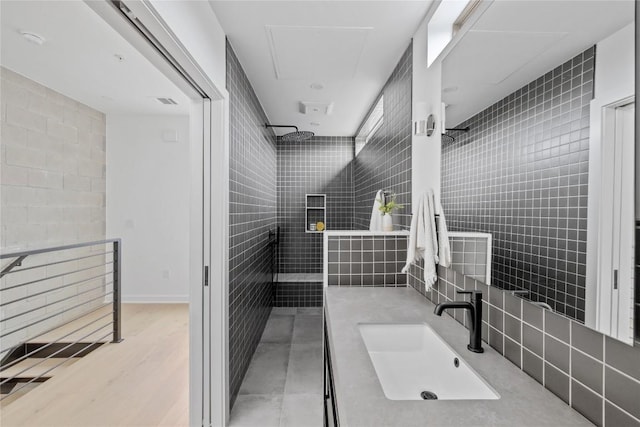 700 Denson Dr Unit 2101, Austin, TX 78752 - full bath featuring walk in shower, vanity, tile walls, and wood finished floors