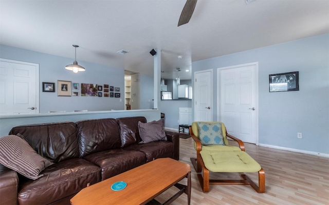 2104 New York Ave, Austin, TX 78702 - living room featuring wood finished floors, baseboards, and a ceiling fan