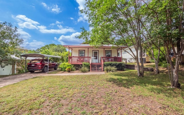2104 New York Ave, Austin, TX 78702 - view of front of home featuring covered porch, a front lawn, a detached carport, metal roof, and driveway