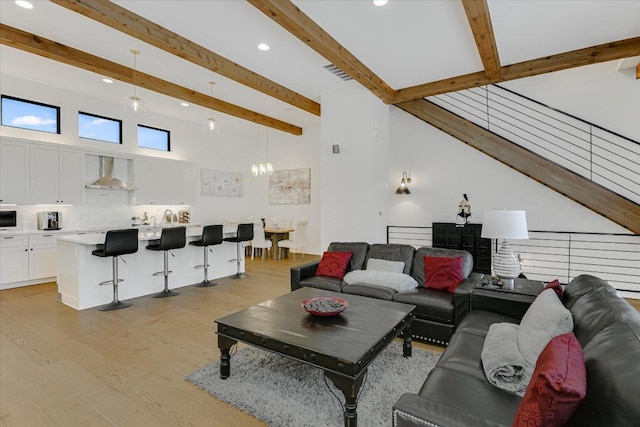 13322 Galleria Cir, Austin, TX 78738 - living area with light wood-style flooring, recessed lighting, beam ceiling, a towering ceiling, and a chandelier