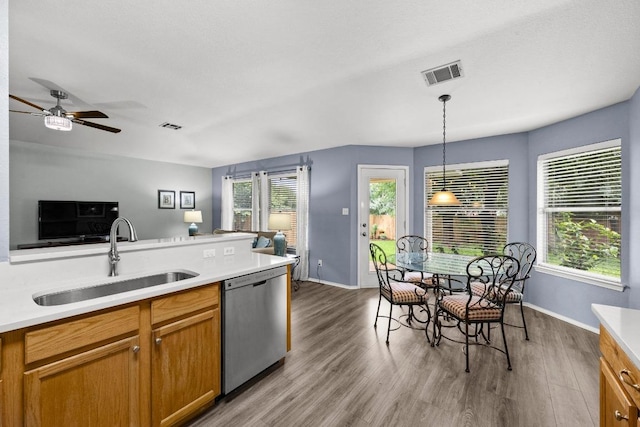 1803 Wallin Loop, Round Rock, TX 78664 - kitchen featuring dishwasher, a sink, open floor plan, and light wood-style floors