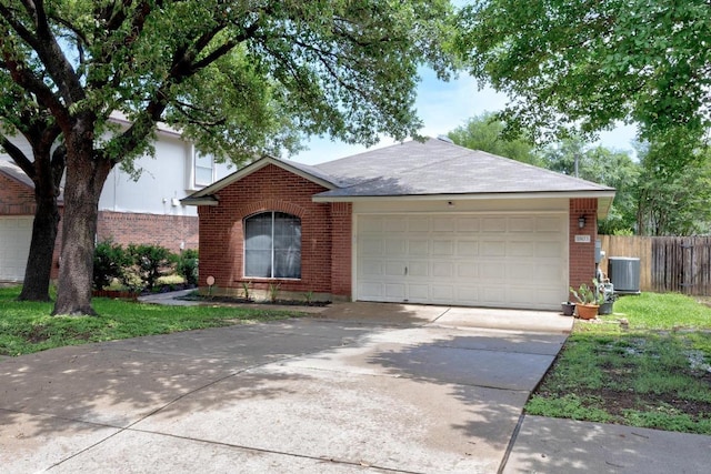 1803 Wallin Loop, Round Rock, TX 78664 - ranch-style house featuring brick siding, an attached garage, central AC, and driveway