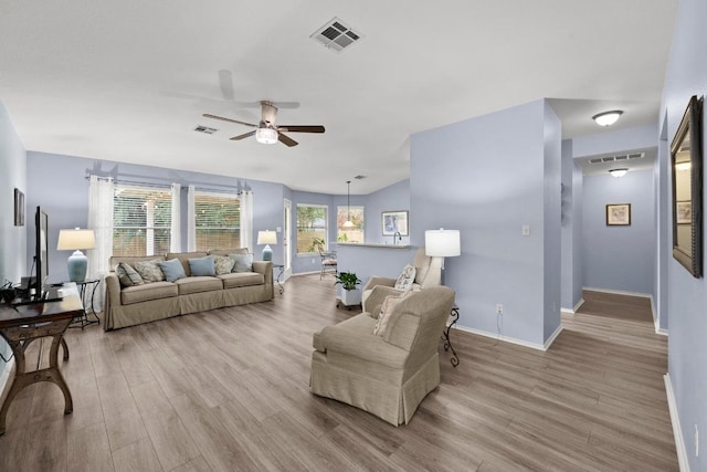 1803 Wallin Loop, Round Rock, TX 78664 - living area with a ceiling fan, wood finished floors, and baseboards