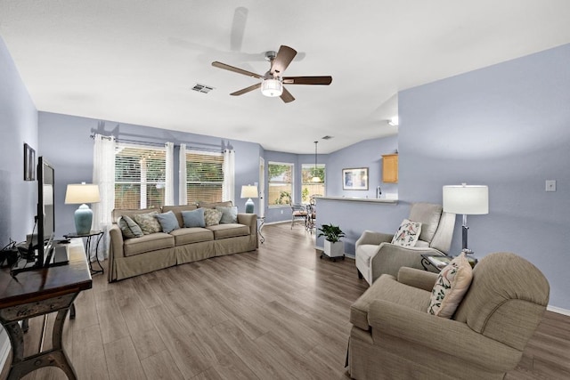 1803 Wallin Loop, Round Rock, TX 78664 - living area with a ceiling fan, wood finished floors, baseboards, and vaulted ceiling