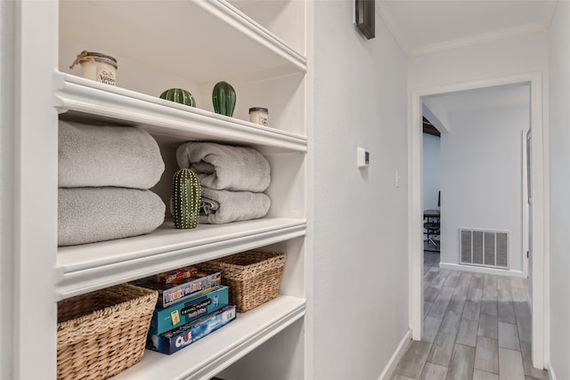 13301 Wisterwood St, Austin, TX 78729 - detailed view of ornamental molding, baseboards, and wood finished floors