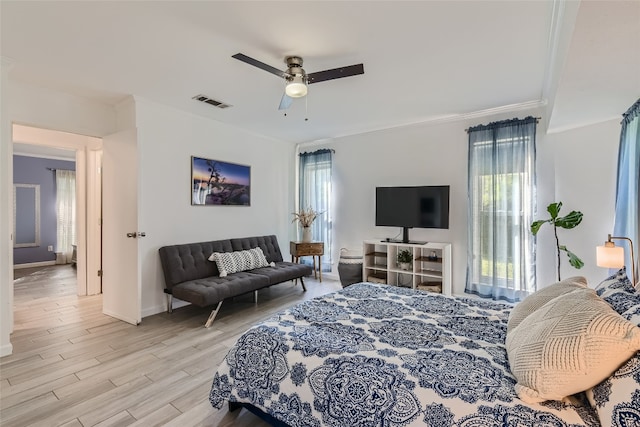 13301 Wisterwood St, Austin, TX 78729 - bedroom featuring light wood finished floors, crown molding, baseboards, and a ceiling fan