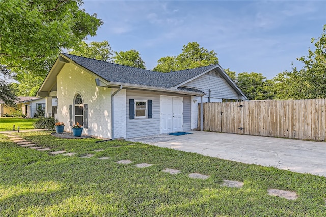 13301 Wisterwood St, Austin, TX 78729 - view of home's exterior with a patio area, a shingled roof, and brick siding