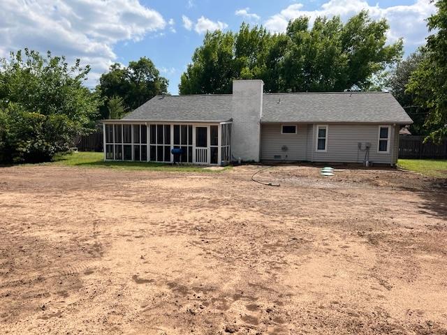 13301 Wisterwood St, Austin, TX 78729 - back of house with a sunroom and a chimney
