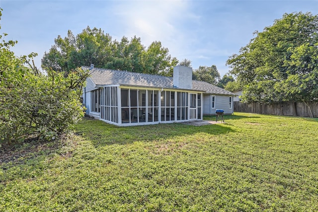 13301 Wisterwood St, Austin, TX 78729 - back of house with a sunroom, a chimney, and a shingled roof