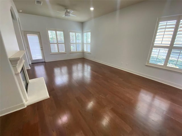 2210 Onion Creek Pkwy Unit 901, Austin, TX 78747 - unfurnished living room featuring a ceiling fan, plenty of natural light, baseboards, dark wood-style flooring, and recessed lighting