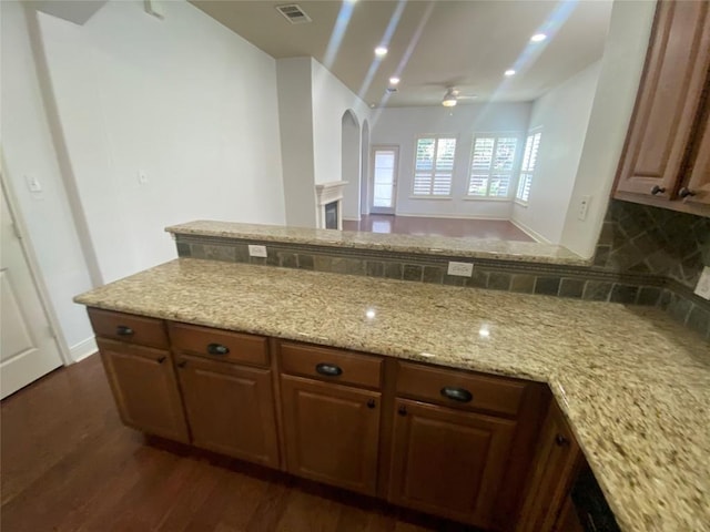 2210 Onion Creek Pkwy Unit 901, Austin, TX 78747 - kitchen with a ceiling fan, dark wood-style flooring, light stone counters, arched walkways, and recessed lighting
