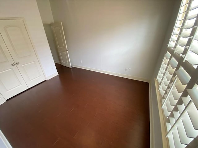 2210 Onion Creek Pkwy Unit 901, Austin, TX 78747 - unfurnished bedroom featuring baseboards and dark wood-type flooring