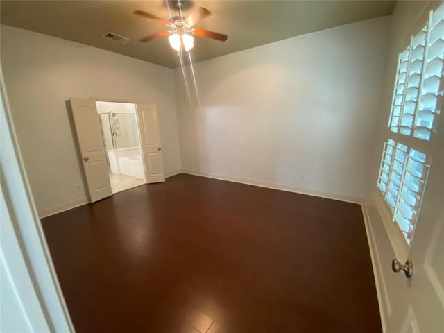 2210 Onion Creek Pkwy Unit 901, Austin, TX 78747 - spare room with a ceiling fan, dark wood-style flooring, and baseboards