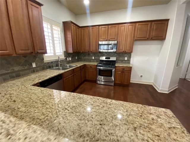 2210 Onion Creek Pkwy Unit 901, Austin, TX 78747 - kitchen with appliances with stainless steel finishes, a sink, light stone countertops, and dark wood finished floors