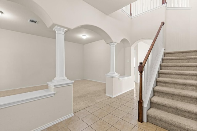 2302 N Ryan Dr, Copperas Cove, TX 76522 - stairway with tile patterned floors, decorative columns, and carpet flooring
