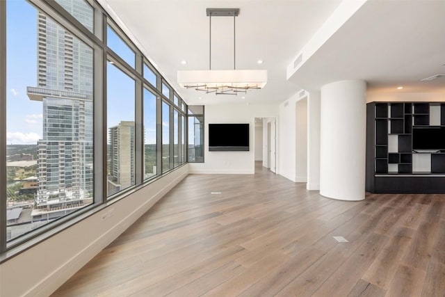 501 W Ave Unit 2303, Austin, TX 78701 - corridor with wood finished floors, baseboards, and rail lighting