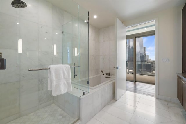 501 W Ave Unit 2303, Austin, TX 78701 - bathroom with a bath, a marble finish shower, tile patterned floors, a city view, and vanity