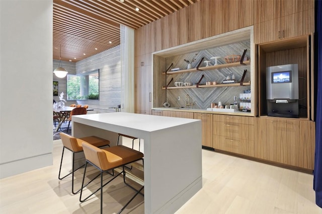 501 W Ave Unit 2303, Austin, TX 78701 - kitchen featuring modern cabinets, a center island, a breakfast bar, light countertops, and open shelves
