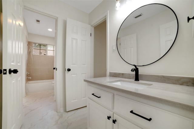 6601 Needham Ln, Austin, TX 78739 - full bathroom featuring vanity, marble finish flooring, and bathing tub / shower combination