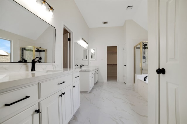 6601 Needham Ln, Austin, TX 78739 - full bath with a stall shower, vanity, marble look tile flooring, a garden tub, and a spacious closet