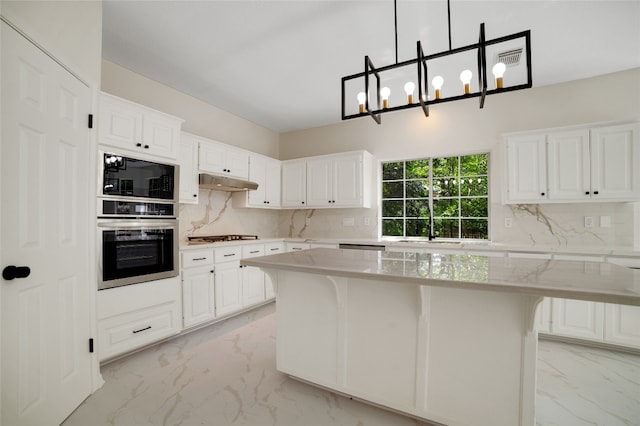 6601 Needham Ln, Austin, TX 78739 - kitchen featuring oven, light marble finish flooring, decorative backsplash, black microwave, and white cabinets