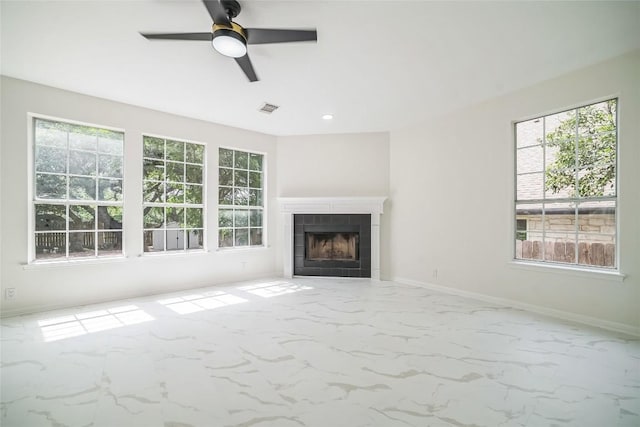 6601 Needham Ln, Austin, TX 78739 - unfurnished living room featuring ceiling fan, a tiled fireplace, baseboards, recessed lighting, and marble finish floors