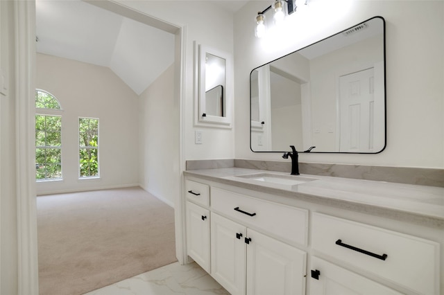6601 Needham Ln, Austin, TX 78739 - bathroom featuring vanity, marble finish flooring, and vaulted ceiling