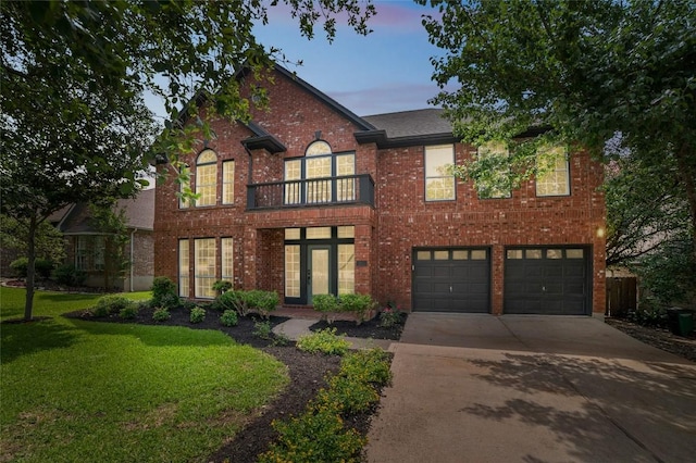6601 Needham Ln, Austin, TX 78739 - georgian-style home featuring a balcony, a garage, concrete driveway, brick siding, and a lawn