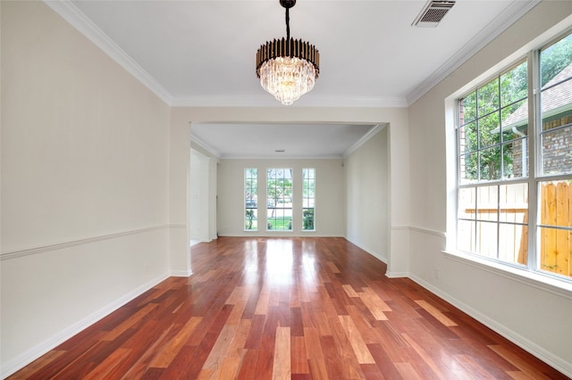 6601 Needham Ln, Austin, TX 78739 - unfurnished room with healthy amount of natural light, a chandelier, wood finished floors, baseboards, and crown molding