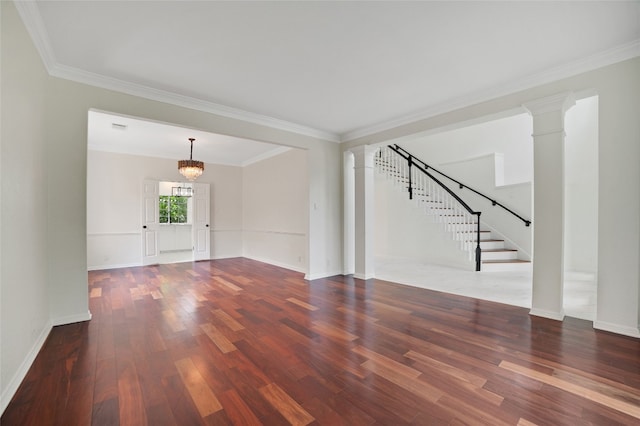 6601 Needham Ln, Austin, TX 78739 - unfurnished living room featuring wood finished floors, decorative columns, ornamental molding, stairs, and a chandelier