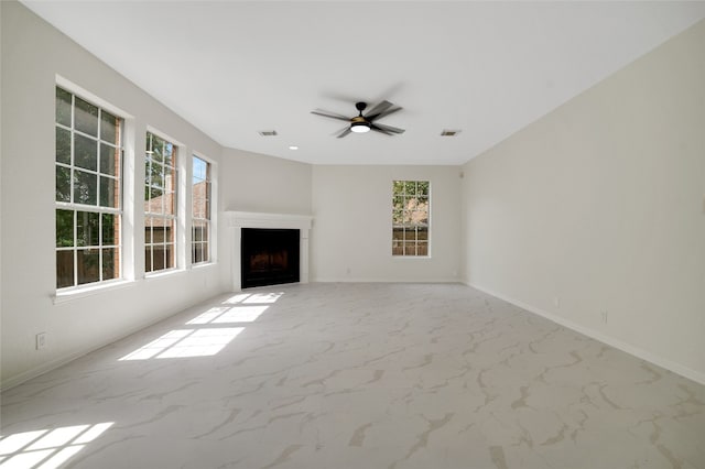 6601 Needham Ln, Austin, TX 78739 - unfurnished living room with a fireplace, ceiling fan, and light marble finish floors