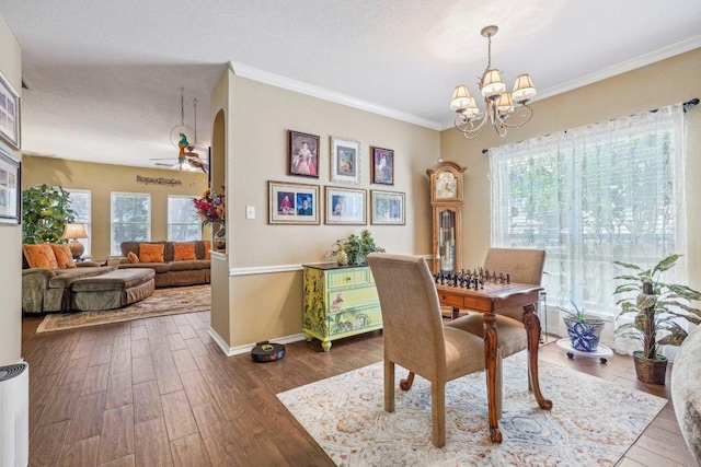 3502 Blackstone Run, San Antonio, TX 78259 - dining space with a chandelier, ornamental molding, dark wood-style floors, baseboards, and arched walkways