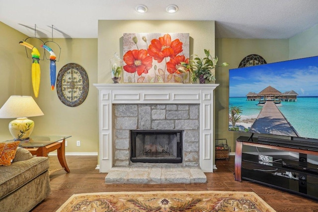 3502 Blackstone Run, San Antonio, TX 78259 - living area with wood finished floors, a stone fireplace, and baseboards