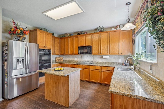 3502 Blackstone Run, San Antonio, TX 78259 - kitchen with black appliances, a sink, light stone counters, tasteful backsplash, and a center island