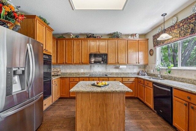 3502 Blackstone Run, San Antonio, TX 78259 - kitchen with black appliances, a sink, dark wood-style flooring, and a kitchen island