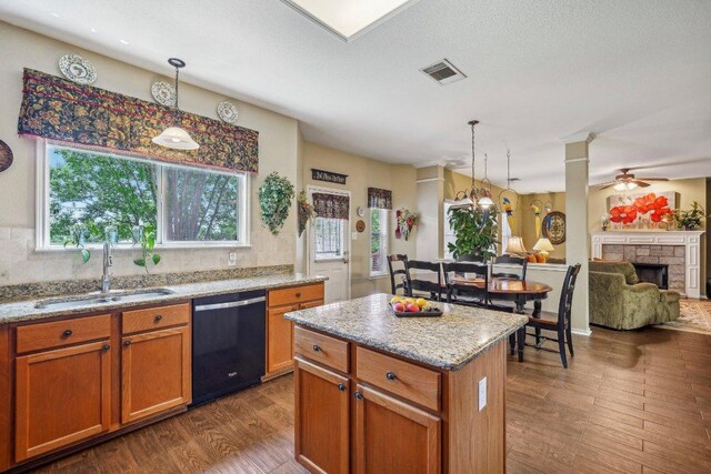 3502 Blackstone Run, San Antonio, TX 78259 - kitchen featuring black dishwasher, a sink, dark wood-type flooring, a kitchen island, and pendant lighting
