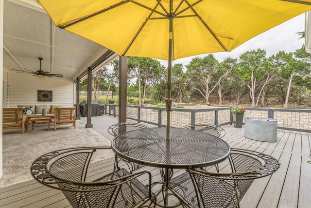 1174 Desiree St, Canyon Lake, TX 78133 - wooden deck with outdoor dining space, a grill, a ceiling fan, and an outdoor living space