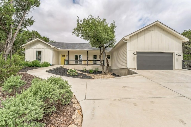 1174 Desiree St, Canyon Lake, TX 78133 - ranch-style home featuring covered porch, concrete driveway, an attached garage, and board and batten siding