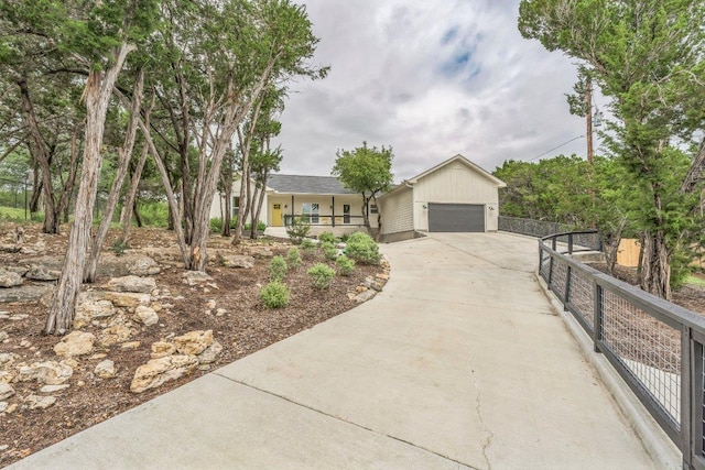 1174 Desiree St, Canyon Lake, TX 78133 - ranch-style house featuring concrete driveway, a porch, and an attached garage