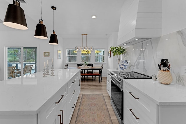 1174 Desiree St, Canyon Lake, TX 78133 - kitchen featuring stainless steel range with electric cooktop, light wood-type flooring, white cabinetry, premium range hood, and recessed lighting
