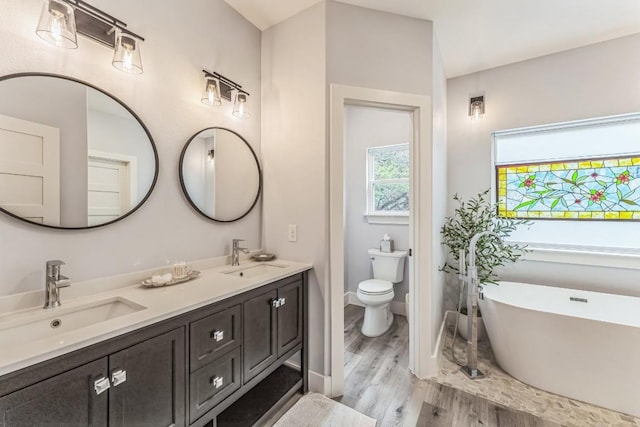 1174 Desiree St, Canyon Lake, TX 78133 - full bath featuring double vanity, a soaking tub, and wood finished floors