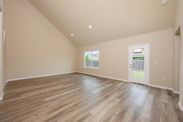 605 Silver Wing Dr, Austin, TX 78725 - spare room featuring wood finished floors, baseboards, recessed lighting, high vaulted ceiling, and a smoke detector