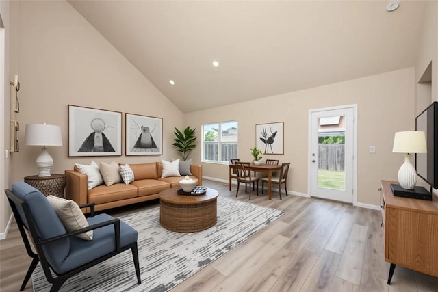 605 Silver Wing Dr, Austin, TX 78725 - living area with healthy amount of natural light, light wood-type flooring, high vaulted ceiling, baseboards, and recessed lighting