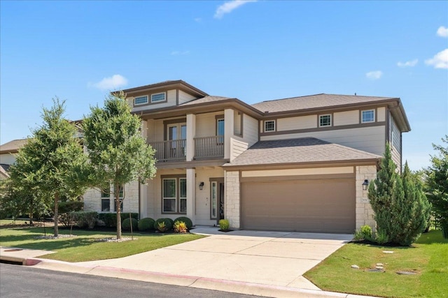 9305 Mcknight Loop Unit 4, Austin, TX 78717 - view of front facade with a balcony, stone siding, a front yard, and a garage